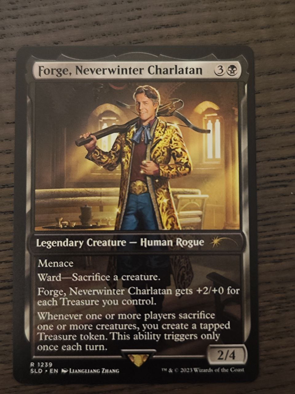 Foto da carta de Magic "Forge, Neverwinter Charlatan" deitada sobre unha mesa negra.